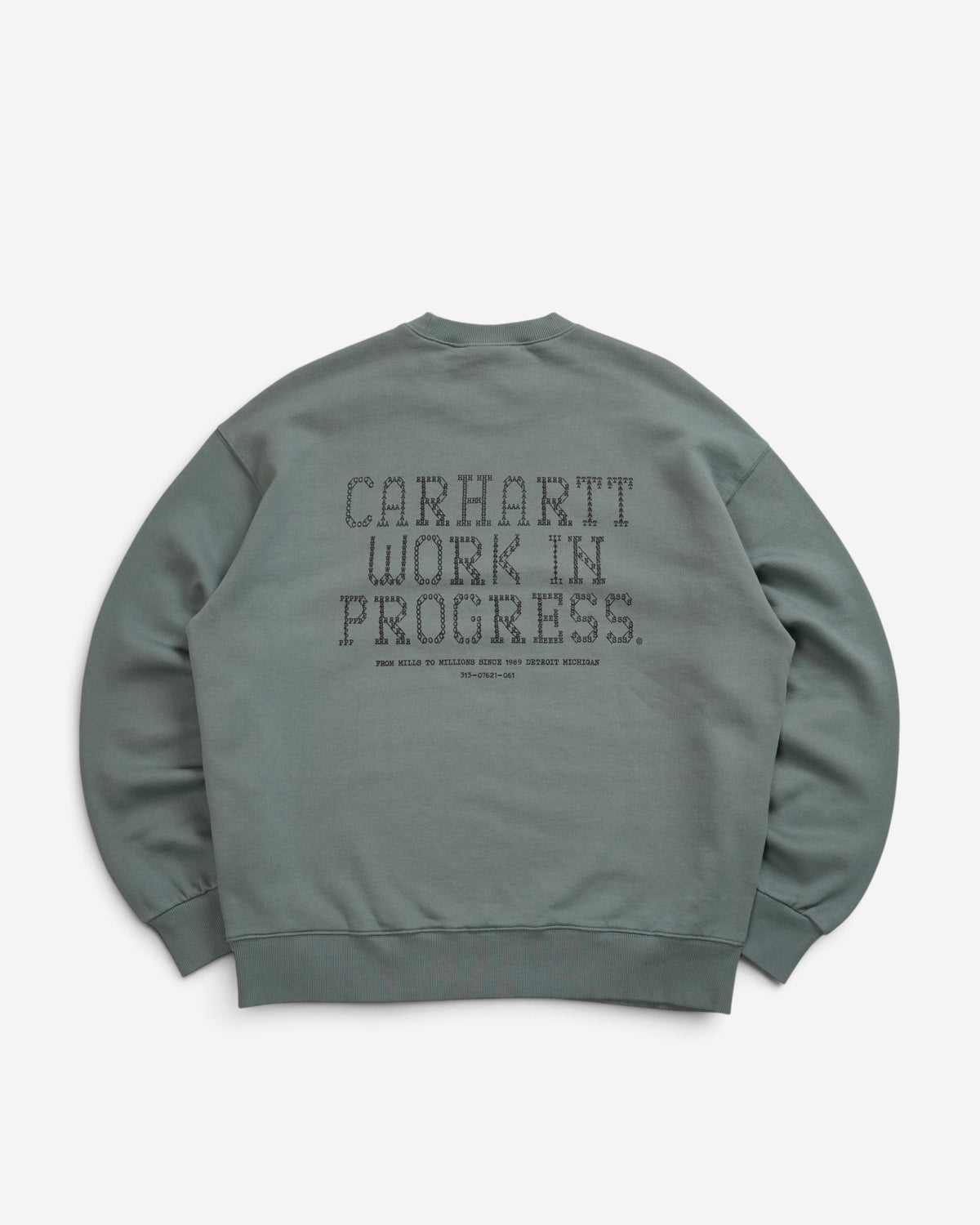 Чоловічий зелений світшот Carhartt WIP Punched колір Velvet Green з великим перфорованим текстовим принтом на спині.
