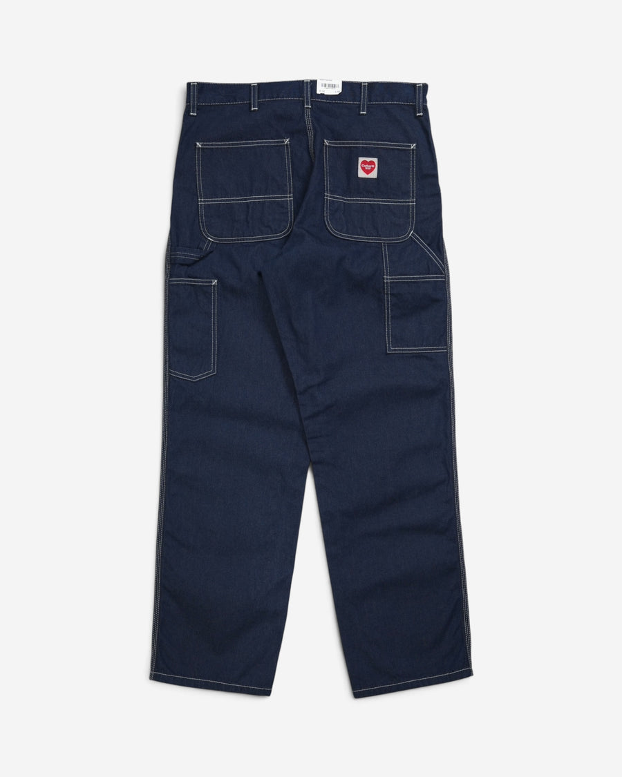Темно-сині джинси Carhartt WIP Single Knee Pant, вигляд ззаду, з великими кишенями, контрастною білою строчкою, петлею для інструментів та нашивкою у формі червоного серця.