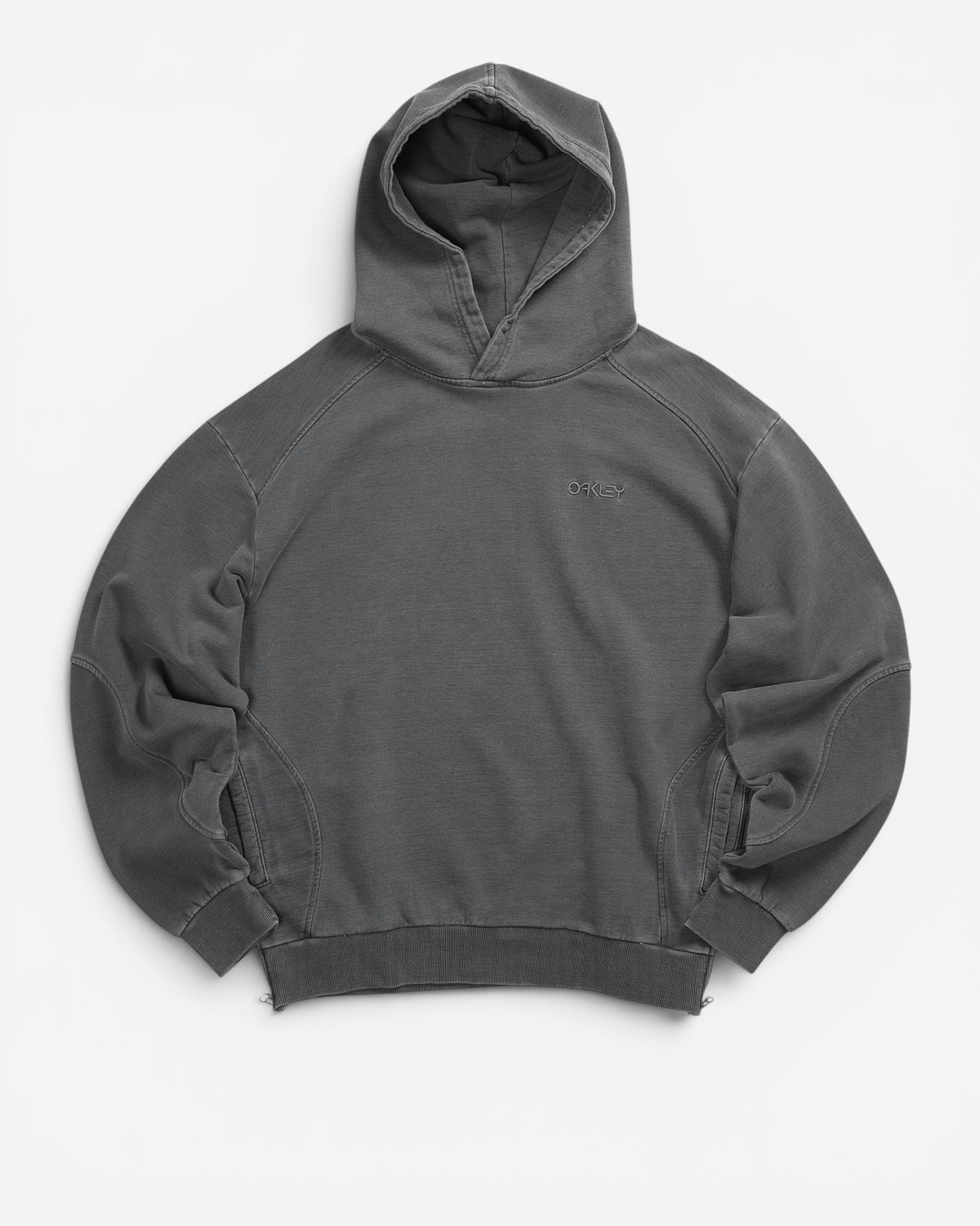 Худі Oakley Indigo Side Zip Hoodie сірого кольору Bleached Grey. Вільний крій оверсайз, 100% бавовна, ефект вицвітання, бічні блискавки. В AND GARMENT.