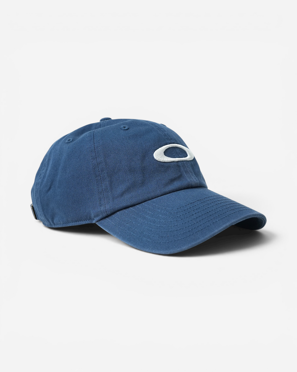 Глибоко-синя бавовняна кепка шестипанельної конструкції Oakley Remix Dad Hat з великим білим овальним логотипом Ellipse на передній панелі.