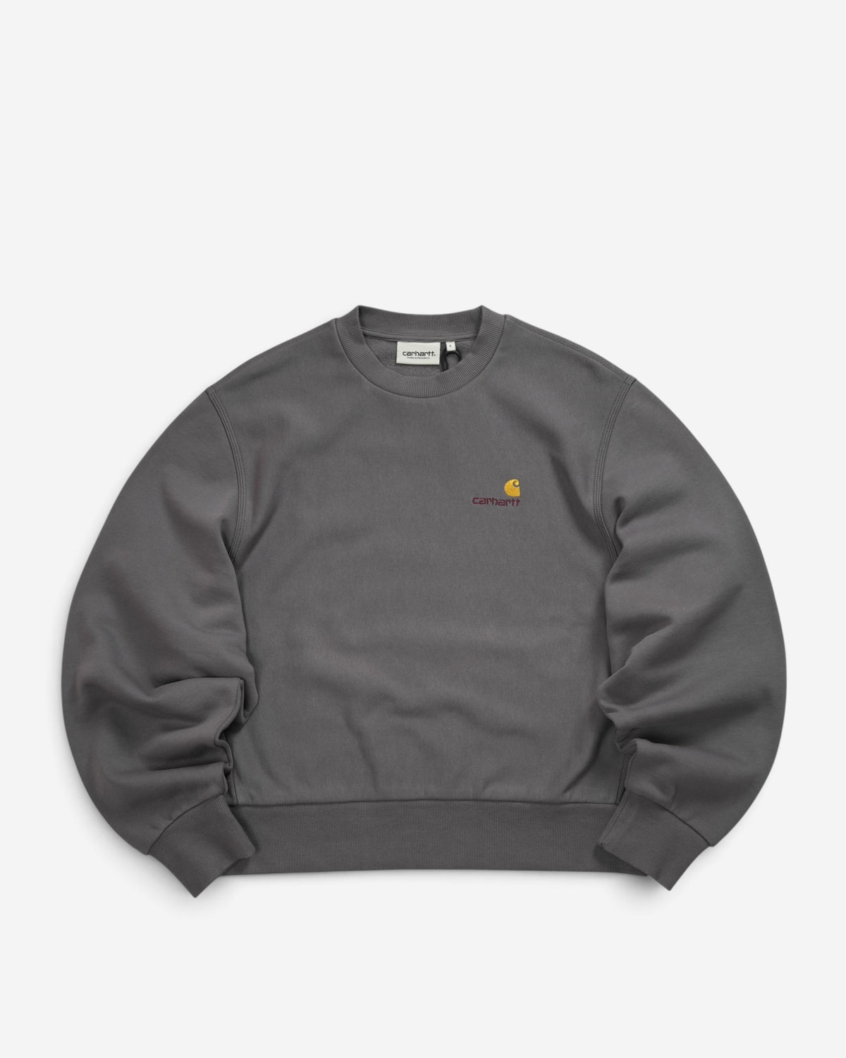 Жіночий сірий світшот Carhartt WIP American Script Graphite з круглим вирізом та невеликим вишитим золотистим логотипом на грудях.